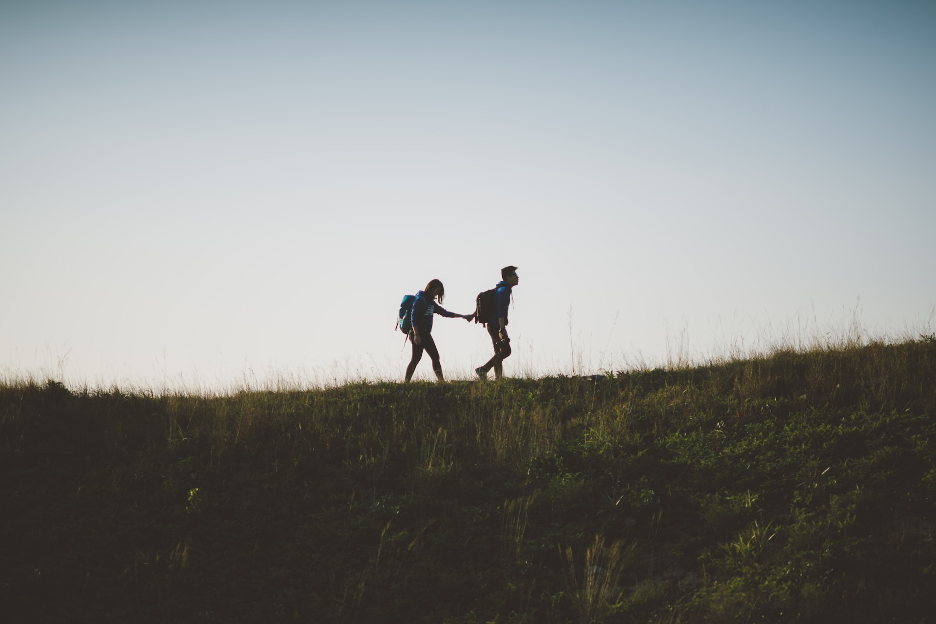 Silhouette of a couple walking on a hill, symbolizing the importance of emotional boundaries.